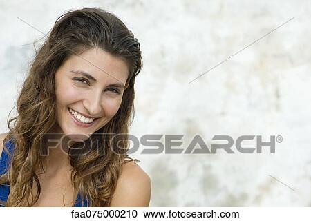 Young woman smiling, portrait View Large Photo Image Stock Image - Young woman smiling, portrait. Fotosearch