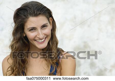 Young woman smiling, portrait View Large Photo Image Stock Image - Young woman smiling, portrait. Fotosearch