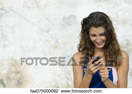 Young woman text messaging View Large Photo Image Stock Image - Young woman text messaging. Fotosearch