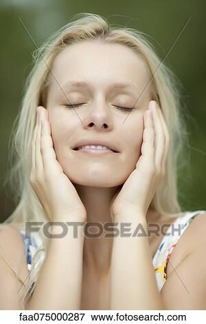 Young woman with head in hands and eyes closed View Large Photo Image Stock Photo - Young woman with head in hands and eyes closed. Fotosearch