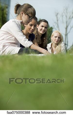 Young women outdoors, low angle view View Large Photo Image Stock Photo - Young women outdoors, low angle view. Fotosearch