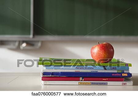 Apple on top of stacked books View Large Photo Image Stock Photo - Apple on top of stacked books. Fotosearch