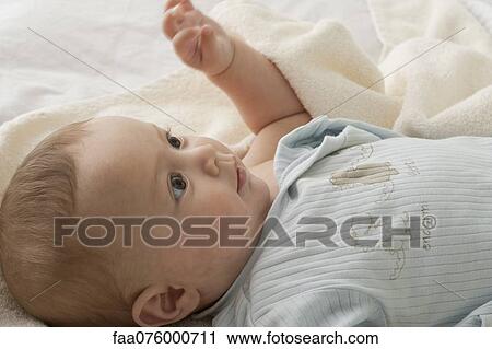 Baby boy lying on back, looking up View Large Photo Image Stock Image - Baby boy lying on back, looking up. Fotosearch