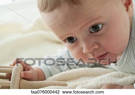 Stock Image - Baby boy playing with toy. Fotosearch