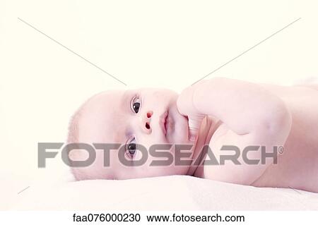 Stock Image - Baby lying on back, portrait. Fotosearch