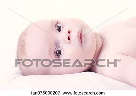 Stock Photo - Baby lying on back, portrait. Fotosearch