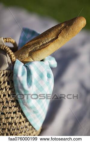 Stock Photo - Baguette in picnic basket. Fotosearch