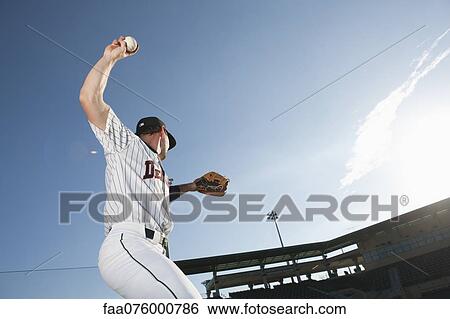 Baseball player throwing ball View Large Photo Image Stock Photograph - Baseball player throwing ball. Fotosearch