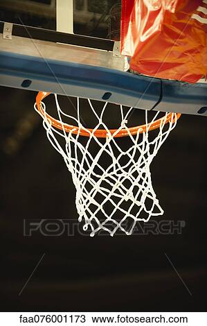 Stock Image - Basketball hoop, low angle view. Fotosearch
