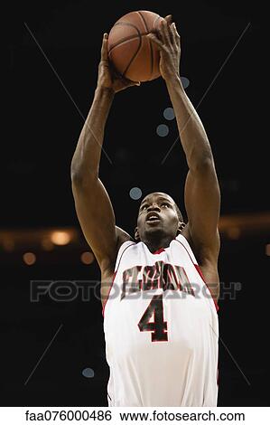 Stock Photograph - Basketball player catching ball. Fotosearch