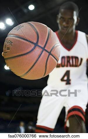 Basketball player dribbling basketball, low angle view View Large Photo Image Stock Photograph - Basketball player dribbling basketball, low angle view. Fotosearch