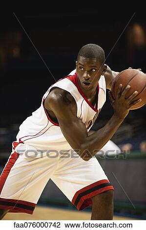 Stock Image - Basketball player focused on game. Fotosearch