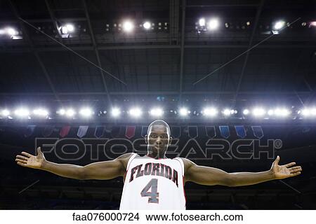 Picture - Basketball player with arms out, portrait. Fotosearch
