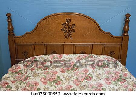 Stock Photo - Bed with wooden headboard. Fotosearch
