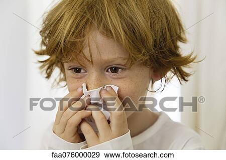 Boy blowing nose on tissue View Large Photo Image Stock Photo - Boy blowing nose on tissue. Fotosearch