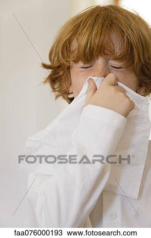 Boy blowing nose on tissue with eyes closed View Large Photo Image Stock Image - Boy blowing nose on tissue with eyes closed. Fotosearch
