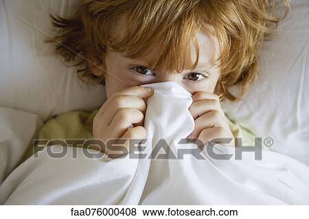 Stock Photo - Boy covering face with sheet, portrait. Fotosearch