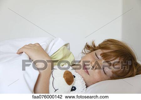 Stock Image - Boy sleeping in bed. Fotosearch