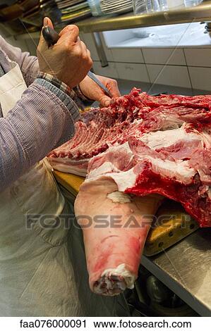 Butcher cutting pork View Large Photo Image Stock Image - Butcher cutting pork. Fotosearch