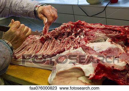 Butcher cutting pork View Large Photo Image Stock Image - Butcher cutting pork. Fotosearch