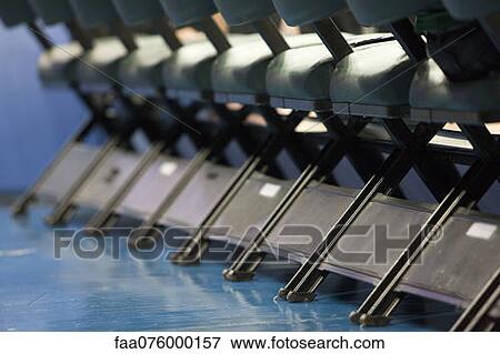 Stock Photo - Chairs in a row, low angle view. Fotosearch
