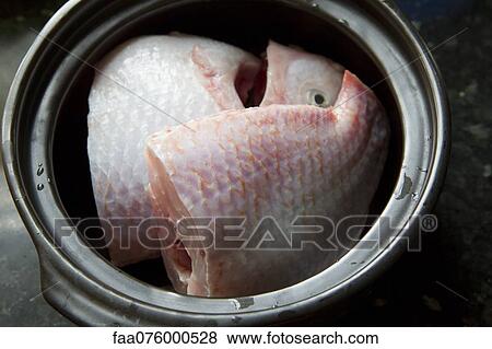Stock Photo - Chopped raw fish in pot. Fotosearch