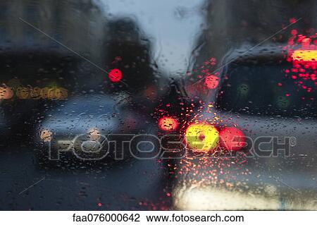 Stock Image - City traffic viewed through window during rain. Fotosearch