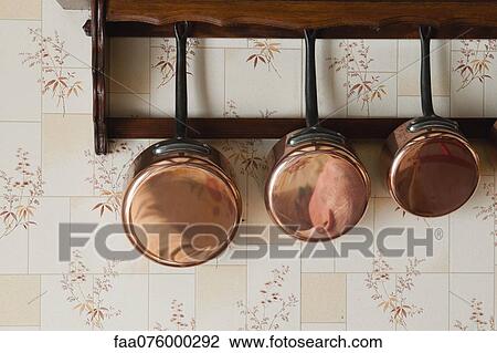 Copper pots hanging on wall rack View Large Photo Image Stock Image - Copper pots hanging on wall rack. Fotosearch