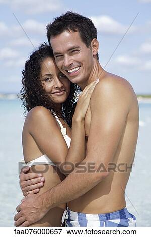 Couple embracing at the beach, portrait View Large Photo Image Stock Photo - Couple embracing at the beach, portrait. Fotosearch