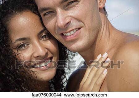 Picture - Couple embracing outdoors, portrait. Fotosearch
