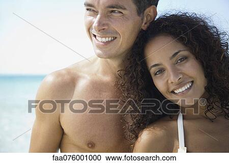 Stock Image - Couple together at the beach, portrait. Fotosearch