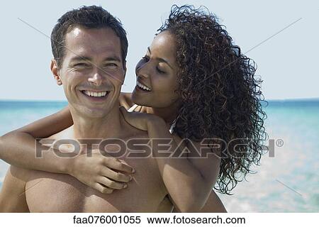 Stock Photography - Couple together at the beach, portrait. Fotosearch