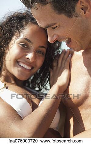 Stock Image - Couple together outdoors, portrait. Fotosearch
