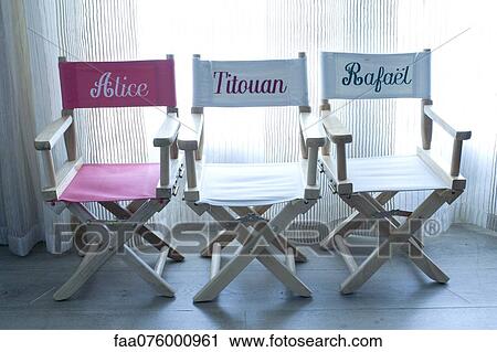 Stock Image - Director's chairs with names embroidered on them. Fotosearch