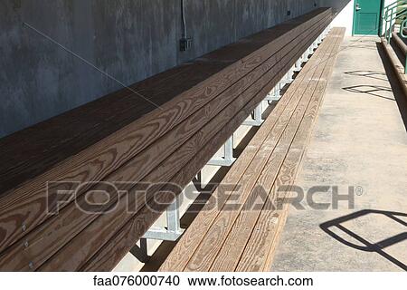 Stock Image - Empty bench in baseball dugout. Fotosearch