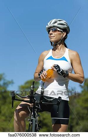 Female cyclist taking break View Large Photo Image Stock Photo - Female cyclist taking break. Fotosearch