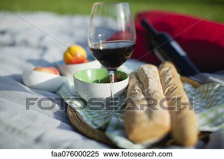 Stock Photography - Food and wine on picnic blanket. Fotosearch