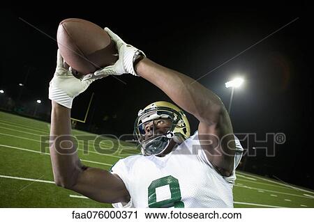 Football player catching ball View Large Photo Image Stock Image - Football player catching ball. Fotosearch