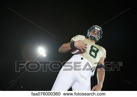 Football player holding ball View Large Photo Image Stock Image - Football player holding ball. Fotosearch