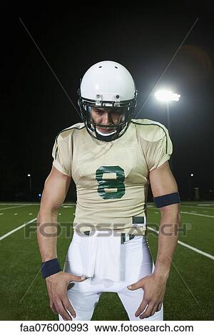 Stock Image - Football player on field, portrait. Fotosearch