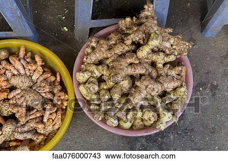 Stock Image - Fresh ginger root and galangal in bowls. Fotosearch