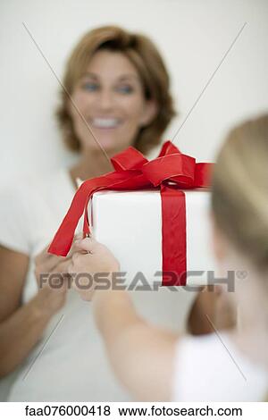 Girl giving mother gift View Large Photo Image Stock Photo - Girl giving mother gift. Fotosearch