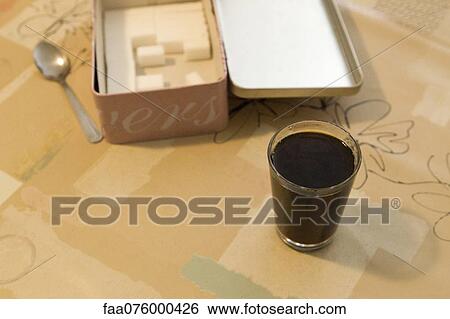 Glass of coffee and box of sugar cubes View Large Photo Image Stock Photograph - Glass of coffee and box of sugar cubes. Fotosearch