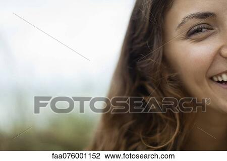 Stock Image - Half of young woman's face, cropped. Fotosearch