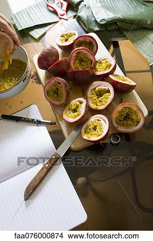 Halved passion fruits on cutting board View Large Photo Image Picture - Halved passion fruits on cutting board. Fotosearch
