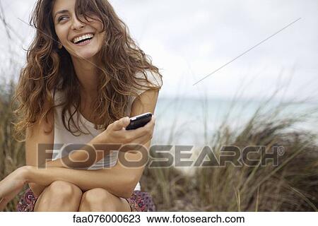 Happy young woman with cell phone View Large Photo Image Stock Image - Happy young woman with cell phone. Fotosearch