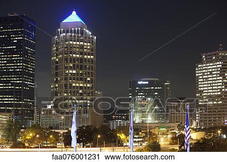 Stock Image - Illuminated office buildings at night. Fotosearch