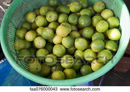 Stock Image - Limes in basket. Fotosearch
