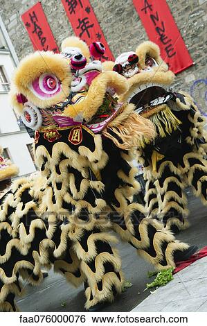 Stock Photograph - Lion dance in celebration of Chinese new year. Fotosearch