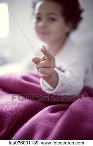 Stock Photo - Little girl pointing at camera. Fotosearch
